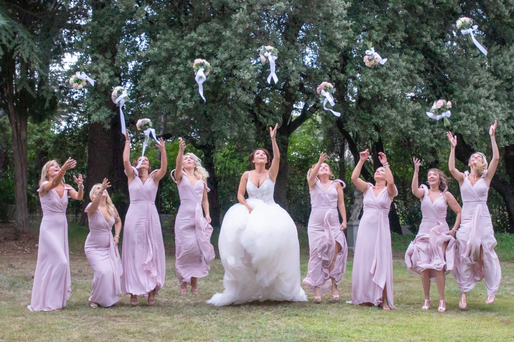 La mariée et ses demoiselles d'honneur jetant en l'air leur bouquet. Au Domaine de la Fouverie à Lorgues. Photo Studio Polidori